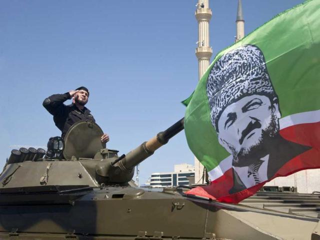 A Chechen special forces officer rides atop an infantry fighting vehicle during Victory Day parade in central Grozny. Fighter jets screamed over Red Square and heavy tanks rumbled over its cobblestones as Russia flexed its military muscle on the anniversary of its costly victory over Nazi Germany in World War II. AFP PHOTO