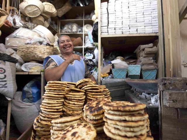 Rosita Navarrete, 62, jokes while preparing corn tortillas at a market in Ibarra city, some 198 km (123 miles) north of Quito. Navarrete says she sells several hundreds of corn tortillas daily to raise her family. Reuters photo