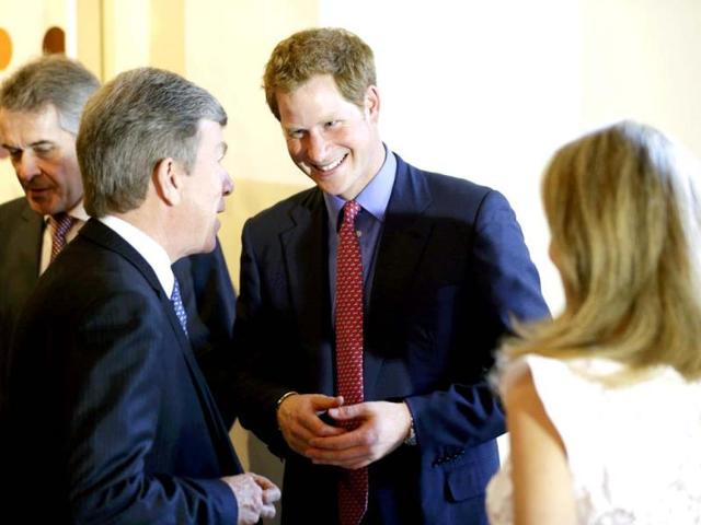 England's Prince Harry speaks with a guest before a reception and dinner at the British Ambassador's residence, in Washington. Reuters photo