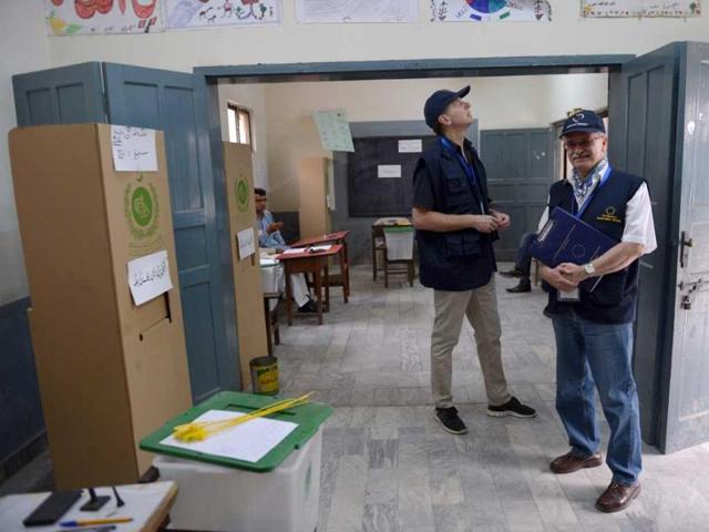 European Election Observation Mission officials examine a polling station before the start of polling in Islamabad. AFP photo