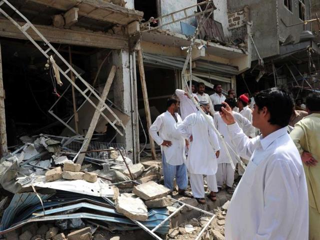 Residents gather at the site of a bomb explosion in Karachi. AFP photo