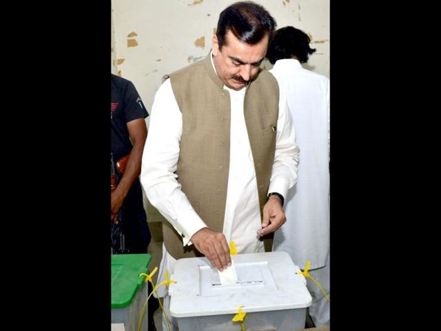 Former Pakistani prime minister Yousuf Raza Gilani casts his vote at a polling station in Multan. (AFP Photo)