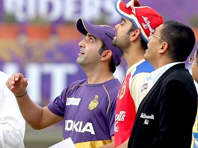 Kolkata Kinight Riders' skipper Gautam Gambhir with his Royal Challengers Banglore counterpart Virat Kohli during toss. (PTI Photo)