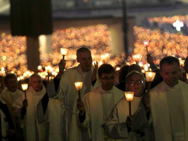 Faithfuls hold candles during a candle light vigil at the Fatima Sanctuary, in Fatima, center Portugal. (AP)