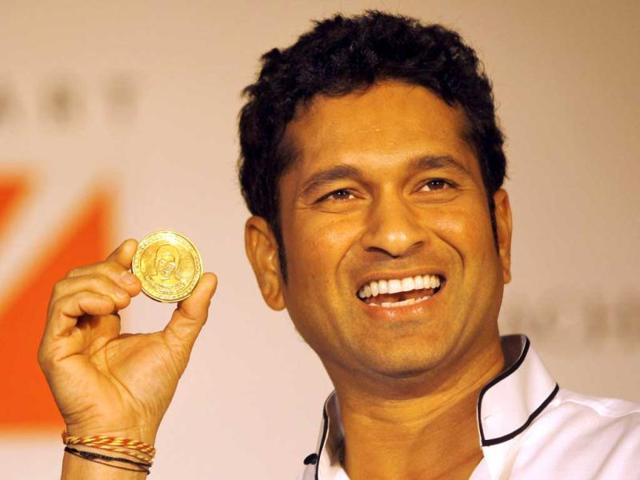 Cricket player Sachin Tendulkar displays a 10 gram gold coin embossed with his face during its unveil on the occasion of 'Akshay Tritiya' in Mumbai. The coin will cost Rs 34,000 (US$620). AP Photo/Rafiq Maqbool)
