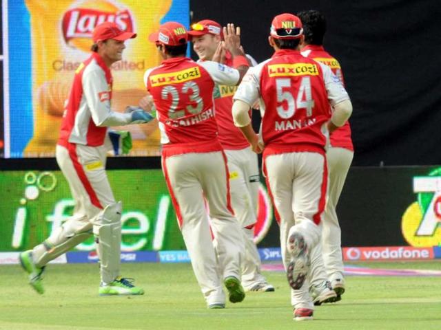 Kings XI Punjab team mates celebrate Royal Challengers Bangalore Pujara's wicket during T20 match at M Chinnaswamy Stadium in Bangalore. (UNI Photo)