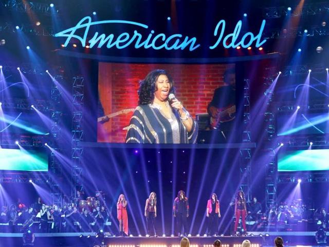 Janelle Arthur, on stage from left, Angie Miller, Candice Glover, Kree Harrison and Amber Holcomb perform with Aretha Franklin, seen on screen, at the American Idol finale at the Nokia Theatre at LA Live in Los Angeles. AP