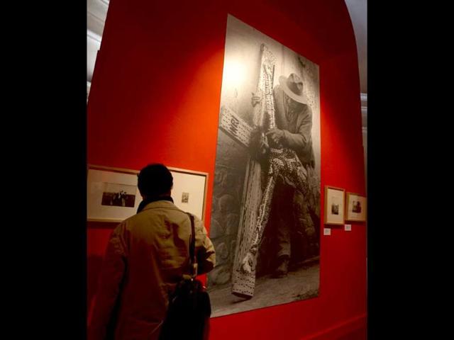 A visitors looks at historical photographs displayed during the unveiling of the exhibition "Argentina. The Gaucho: Tradition, Art and Faith", in the Carlo Magno wing of Bernini's colonnade in St. Peter's Square at the Vatican. (AP Photo)
