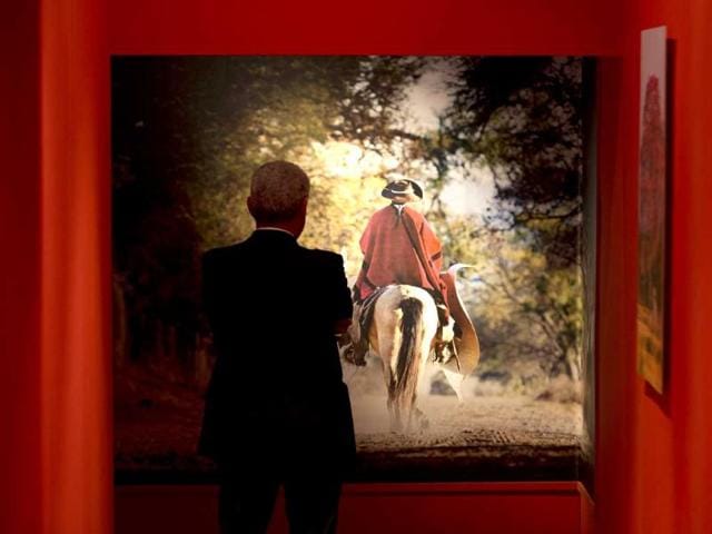 A visitor looks at a photograph during the unveiling of the exhibition "Argentina. The Gaucho: Tradition, Art and Faith", in the Carlo Magno wing of Bernini's colonnade in St. Peter's Square at the Vatican. (AP Photo)
