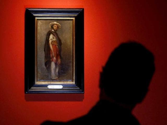 A person looks at a painting of a gaucho during an exhibition in St. Peter's square at the Vatican. (Reuters)