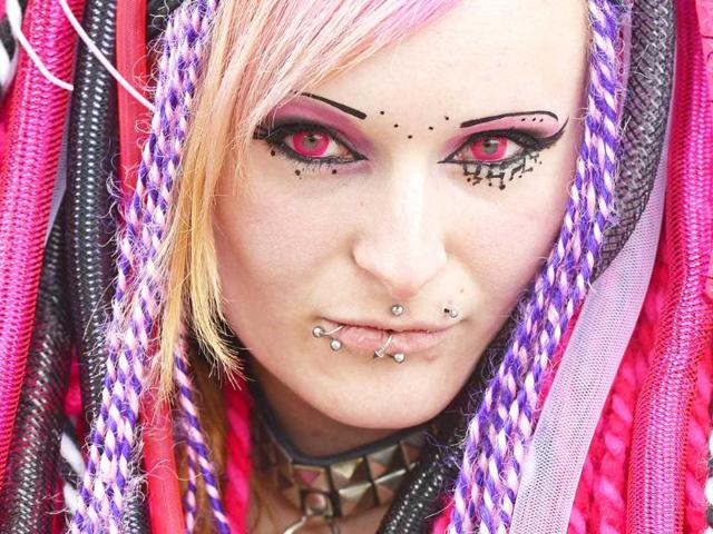 A participant of the gothic music festival Wave Gothic Festival in a fancy costume poses for a photograph as she walks in Leipzig, central Germany. About 20,000 members of the scene from all over the world are expected to attend the gothic and 'dark' culture festival. AP