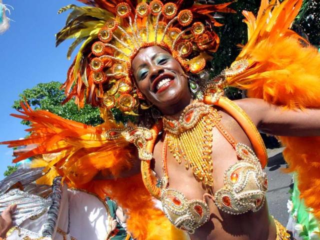 A dancer in a colorful costume performs during a parade through the streets of Berlin as part of the Carnival of Cultures festival. AFP