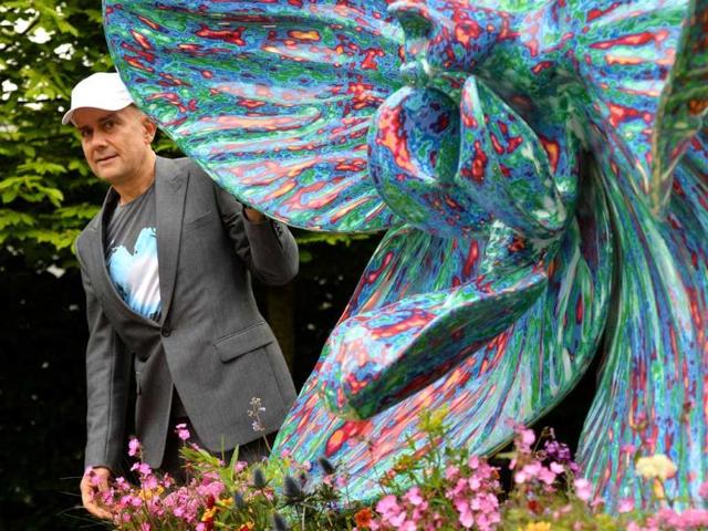 British artist Marc Quinn poses with his sculpture of an orchid in the Royal Horticultural Society (RHS) garden during the Chelsea Flower Show press day in London. AFP Photo