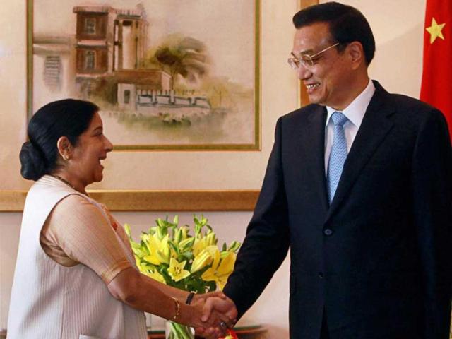 Chinese Premier Li Keqiang and leader of opposition in Lok Sabha Sushma Swaraj shake hands at a meeting in New Delhi. PTI Photo