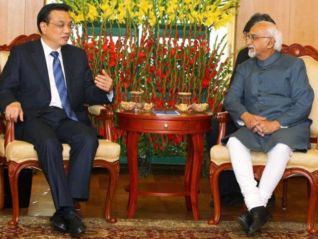 Vice President Hamid Ansari (R) talks with Chinese Premier Li Keqiang during a meeting in New Delhi. PTI Photo