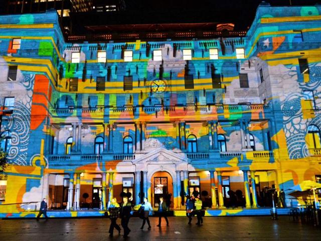 People walk past a light installation as landmarks around the city become part of Sydney's annual festival of light, music and ideas. (AFP)