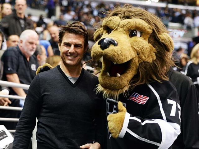 Actor Tom Cruise poses for a picture with Los Angeles Kings mascot in Game Five of the Western Conference Semifinals during the 2013 Stanley Cup Playoffs at Staples Center, Los Angeles, California. AFP Photo
