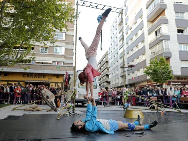 People attend a performance by members of Spanish group Arritmados during The International Festival of Street Theatre and Arts of Valladolid in the center of Valladolid. AFP PHOTO