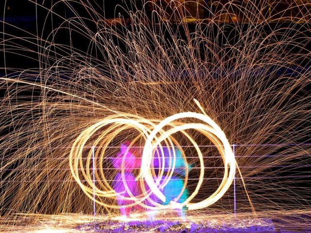 Long exposure photo shows fire spinners whirling fire as they take part in a two-day Fire Festival "Miff-2013" in Minsk, Belarus. AP