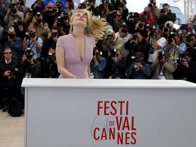 Emmanuelle Seigner swishes her short hair