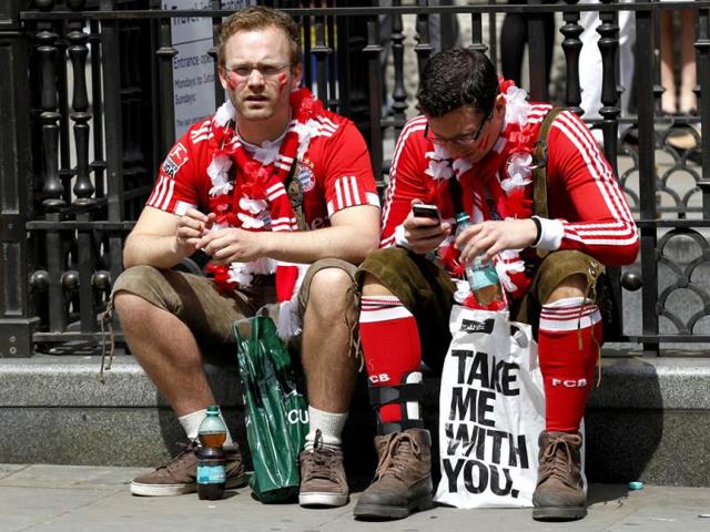 Two Bayern Munich supporters take a rest in Piccadilly Circus as supporters of Boussia Dortmund and Bayern Munich gather in central London ahead of their Champions League final soccer match at Wembley Stadium on Saturday. AP Photo