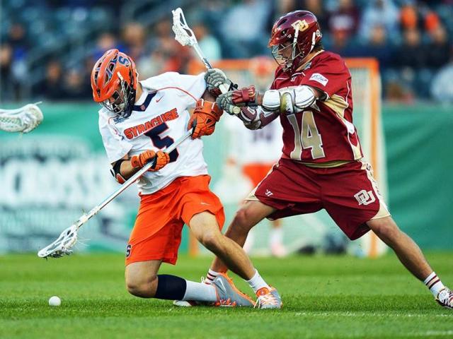 Joe Fazio #5 of the Syracuse University Orange goes for a loose ball while getting hit by Wesley Berg #14 of the University of Denver Pioneers during a semifinal game of the 2013 NCAA Division I Men's Lacrosse Championships at Lincoln Financial Field in Philadelphia, Pennsylvania. Syracuse won 9-8. (AFP)