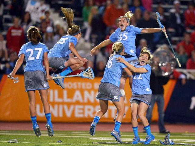 Aly Messinger #27, Taylor George #23, Sloane Serpe #16, Brittney Coppa #35 and Emily Garrity #22 of University of the North Carolina Tar Heels celebrate their 13-12 overtime win for the 2013 NCAA Division I Women's Lacrosse Championship at Villanova Stadium in Villanova, Pennsylvania. AFP/Getty Images