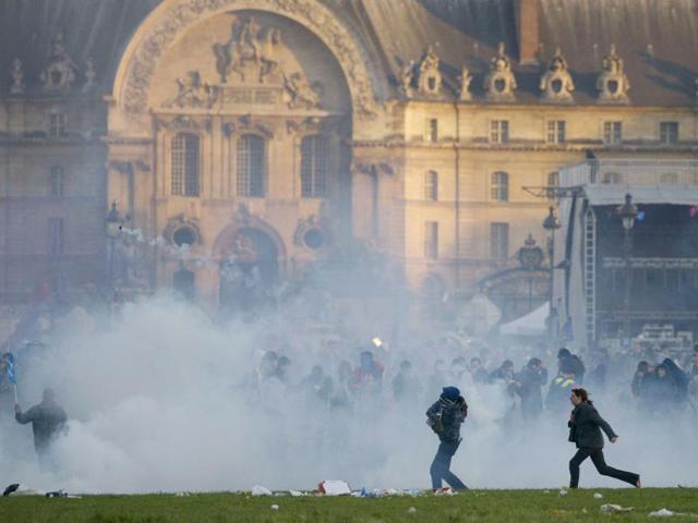 Protesters stand in tear gas smoke in Paris on the sidelines of demonstrations against a gay marriage law. France on May 18 became the 14th country to legalise same-sex marriage after President Francois Hollande signed the measure into law following months of bitter debate and demonstrations. AFP