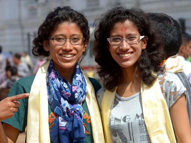 Indian mountaineers Tashi and Nancy Malik, noted for being the first twin sisters to summit Everest earlier this month, pose while participating in a procession for Everest summitteers during the Mount Everest Diamond Jubilee celebrations in Kathmandu. AFP PHOTO