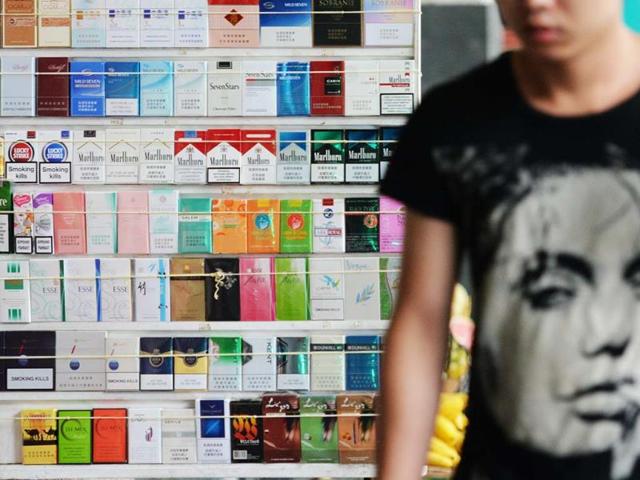 A man passes by a tobacco shop in Shanghai on World No Tobacco Day. AFP photo