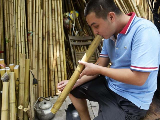 A man tests a bamboo smoking pipe, which are currently more popular in the countryside than in cities in downtown Hanoi on World No Tobacco Day. AFP photo