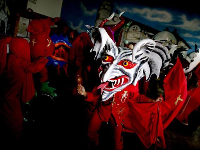 A participant of the "Diablos Danzantes" (Dancing Devils) of Yare performs to mark the Feast of Corpus Christi in San Francisco de Yare. The dancers perform the ritual dance celebrating the transformation of the body and blood of Christ into bread and wine. (Reuters)