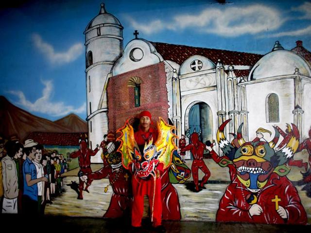 A participant of the "Diablos Danzantes" (Dancing Devils) of Yare performs to mark the Feast of Corpus Christi in San Francisco de Yare. The dancers perform the ritual dance celebrating the transformation of the body and blood of Christ into bread and wine. (Reuters)