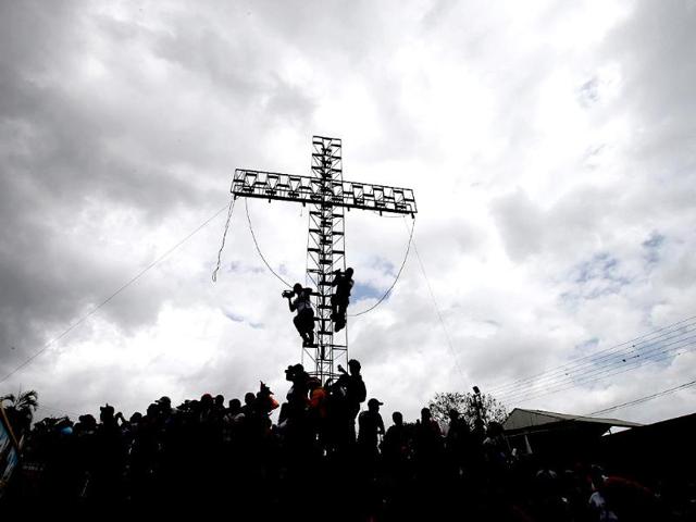 Tourists take position to watch a dancing devil parade during Corpus Christi, a festival celebrating the transformation of the body and blood of Christ into bread and wine, in San Francisco de Yare, Venezuela. (AP)