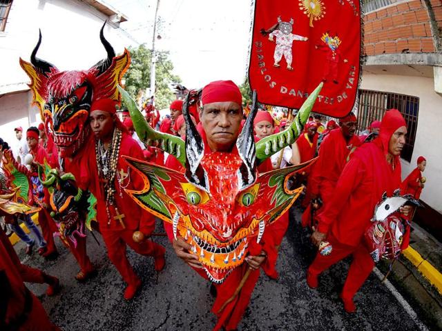 The "Diablos Danzantes" (Dancing Devils) of Yare dance to mark the Feast of Corpus Christi in San Francisco de Yare. The dancers perform the ritual dance celebrating the transformation of the body and blood of Christ into bread and wine. (Reuters)