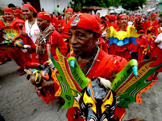 Men dressed as a dancing devils perform on the streets of San Francisco de Yare, Venezuela to mark the annual celebration of Corpus Christi, a festival celebrating the transformation of the body and blood of Christ into bread and wine, on the streets of La Villa, Panama. (AP)