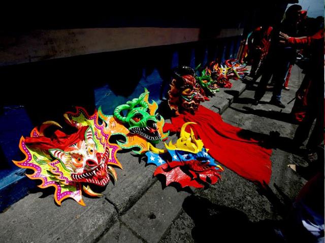 Devil masks lay on the ground during the annual commemoration of Corpus Christi, a festival celebrating the transformation of the body and blood of Christ into bread and wine, in San Francisco de Yare, Venezuela. (AP)