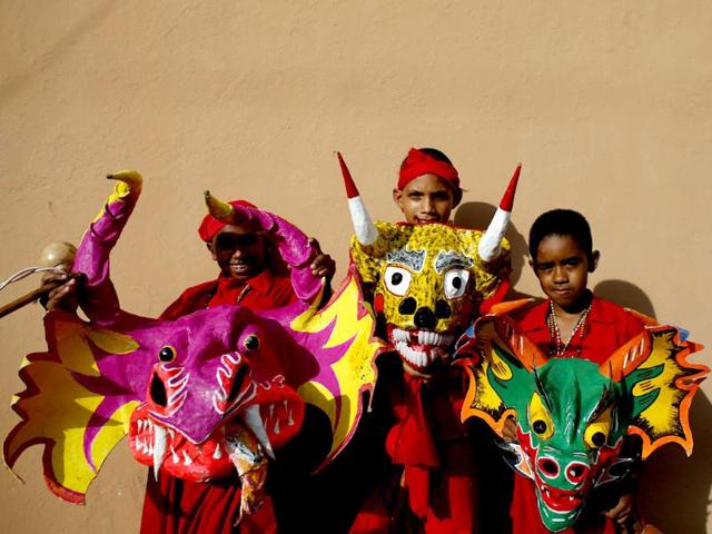 Participants of the "Diablos Danzantes" (Dancing Devils) of Yare pose with their masks to mark the Feast of Corpus Christi in San Francisco de Yare. The dancers perform the ritual dance celebrating the transformation of the body and blood of Christ into bread and wine. (Reuters)