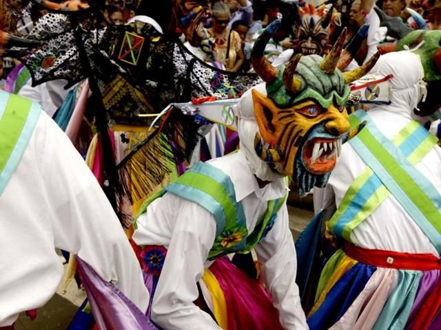 Dancers wearing traditional devil masks and costumes dance during Corpus Christi celebrations on the streets of La Villa, Panama. The festival celebrates the transformation of the body and blood of Christ into bread and wine. (AP)
