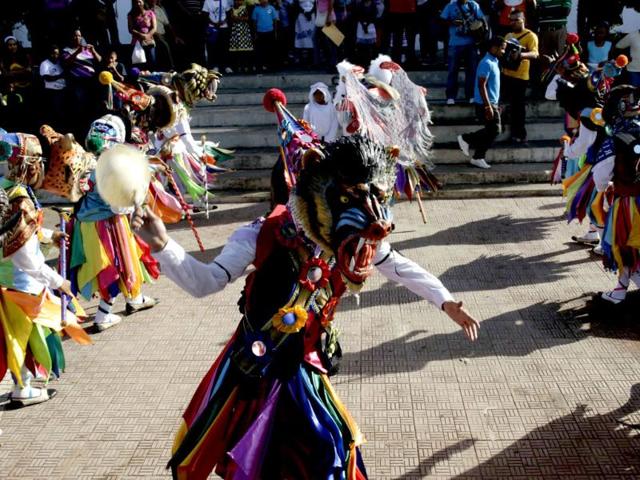 A man dressed in traditional costume as a "diablo" (devil) takes part in the traditional dance during the annual Corpus Christi celebration in La Chorrera on the outskirts of Panama City. The annual festival celebrates the transformation of the body and blood of Christ into bread and wine. (Reuters)
