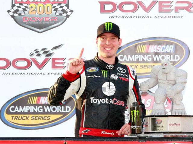 Kyle Busch, driver of the #51 ToyotaCare Toyota, celebrates with the tropy in Victory Lane after winning the NASCAR Camping World Truck Series Lucas Oil 200 at Dover International Speedway in Dover, Delaware. (AFP)