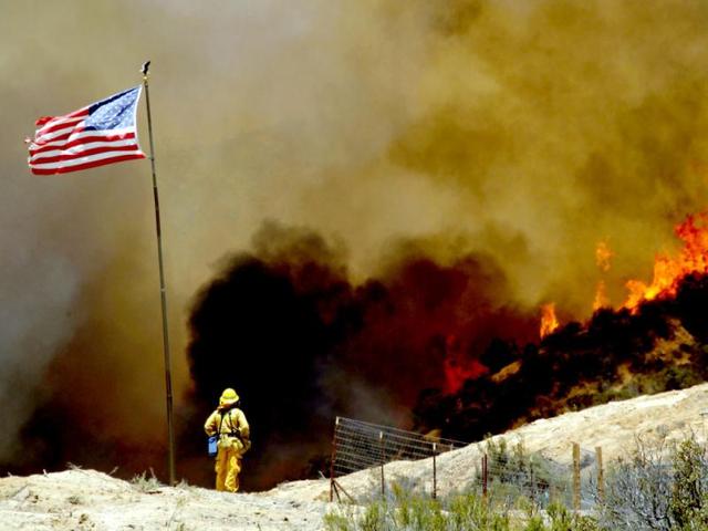 A firefighter watches a 1,400-acre wildfire northeast of Castaic, California. (AP)