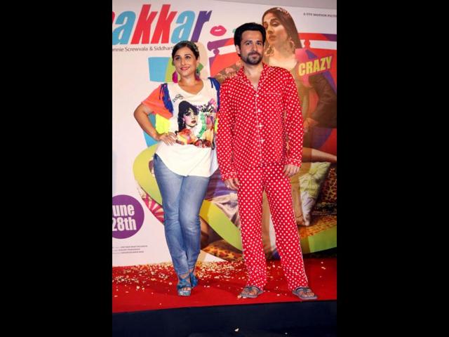 Viday Balan and Emraan Hashmi pose with the poster of their upcoming film Ghanchakkar in Mumbai. (AFP Photo)