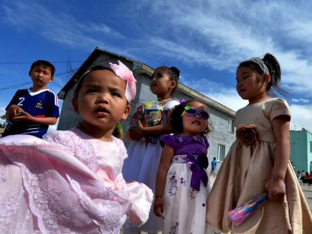 Mongolian children watch a show at a carnival to celebrate International Children's Day at the Mongolian town of Bayangol. Mongolia, along with current and former Communist countries, celebrates its Children's Day on June 1. (AFP)