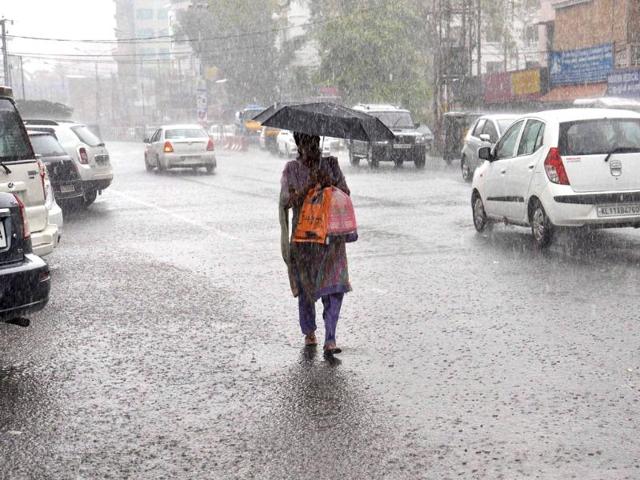 A-woman-walks-with-an-umbrella-on-a-rainy-day-in-Kochi-PTI A-woman-walks-with-an-umbrella-on-a-rainy-day-in-Kochi-PTI