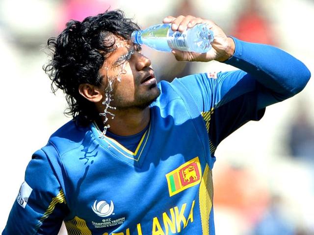 Sri Lanka's Kusal Perera pours water on his face during the warm-up cricket match ahead of the 2013 ICC Champions Trophy between India and Sri Lanka at Edgbaston in Birmingham. AFP/Andrew Yates