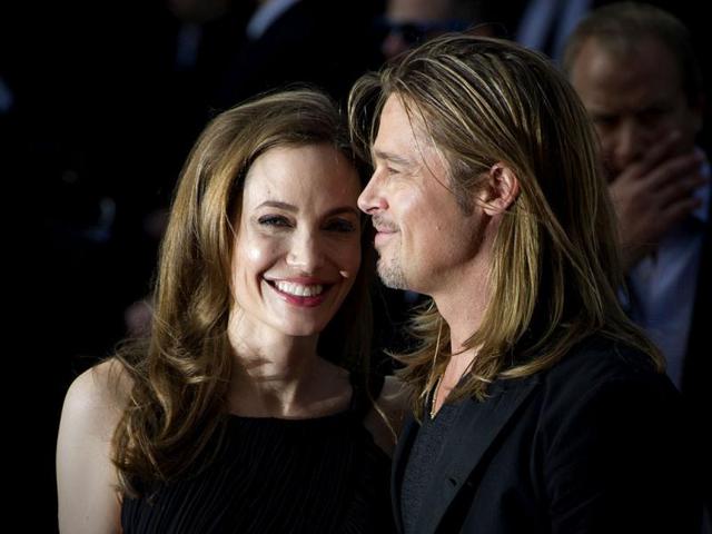 US actress and humanitarian campaigner Angelina Jolie (L) poses with her fiance and actor Brad Pitt (R) as she arrives for the UK premiere of Brad Pitt's latest film "World War Z" in Leicester Square in central London. (AFP Photo)