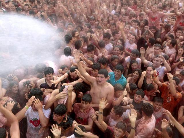 Revellers are sprayed with water during the annual "Tomatina" (tomato fight) in Sutamarchan province in Boyaca. Reuters/John Vizcaino