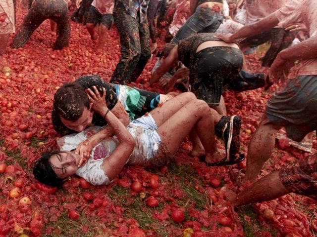 Revellers play with tomato pulp during the annual "Tomatina" (tomato fight) in Sutamarchan province in Boyaca. Reuters/John Vizcaino