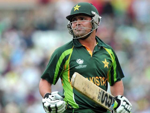 Imran Farhat leaves the pitch after being caught out by West Indies Dwayne Bravo during the 2013 ICC Champions Trophy cricket match between Pakistan and West Indies at The Oval cricket ground in London. (AFP)